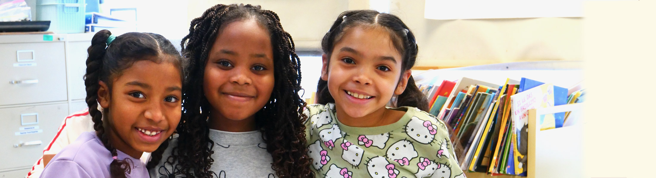 Group of 3 students together and smiling